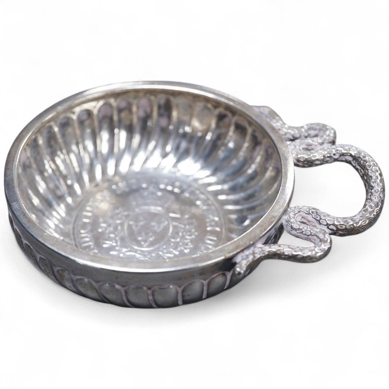A late 18th century French white metal taste vin, with serpent handle and inset coin base, cockerel mark, 93mm, 96 grams.